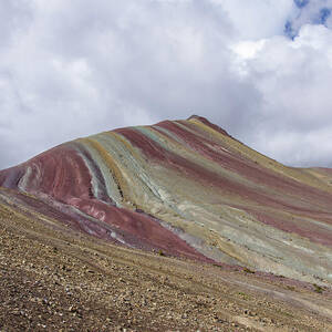 Colorful Rainbow Mountain Under Cloudy Sky by Brandon Wichmann