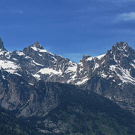 Snow-Capped Teton Mountain Peaks Under Blue Sky by Brandon Wichmann