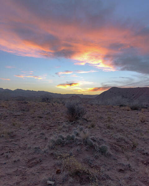 Desert Sunset Over Rugged Terrain Poster