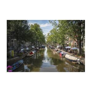 Serene Amsterdam Canal with Boats and Trees by Brandon Wichmann Serene Amsterdam Canal with Boats and Trees by Brandon Wichmann