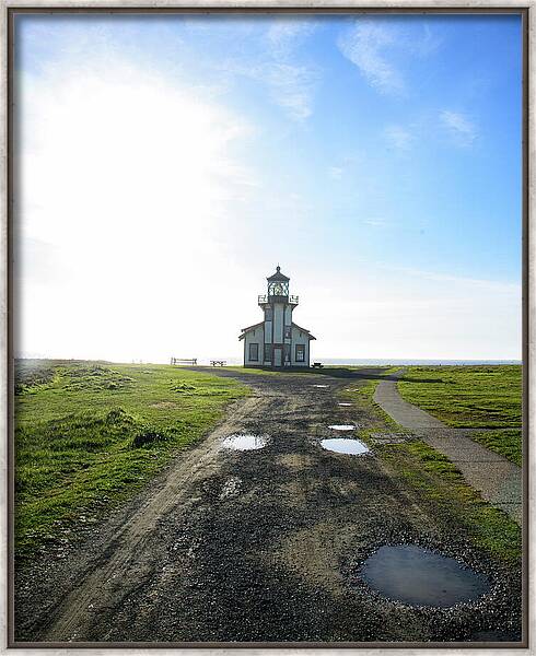 Lighthouse Under A Bright Sky Framed Print