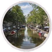 Serene Amsterdam Canal With Boats And Trees Round Beach Towel