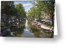 Serene Amsterdam Canal With Boats And Trees Greeting Card