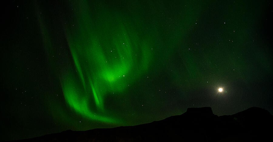Aurora Curling Around the Moonlit Sky
