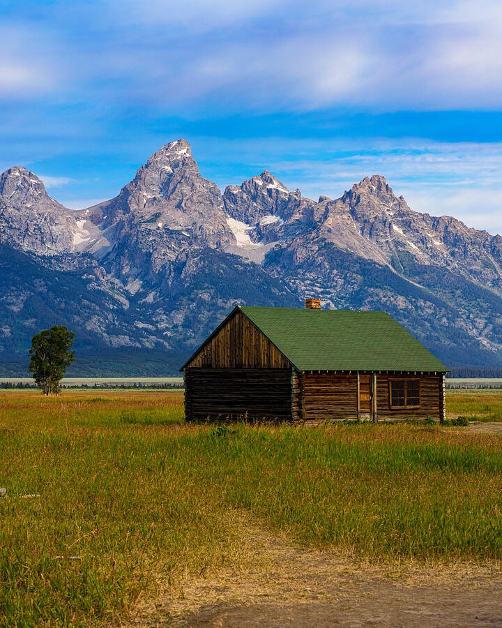 A Quiet Cabin Below the Mountain Wall