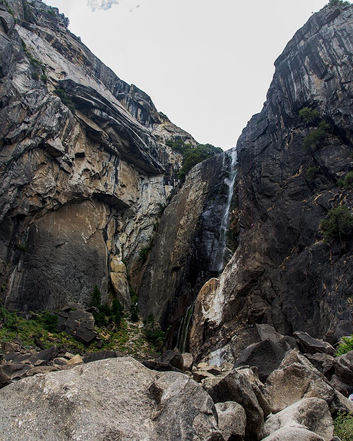 A Slender Waterfall Between Granite Walls