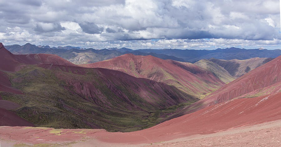 Red Ridges Beneath the Broken Clouds