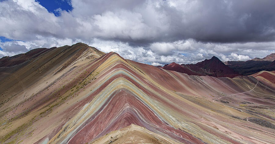 A Striped Mountain Beneath Heavy Clouds