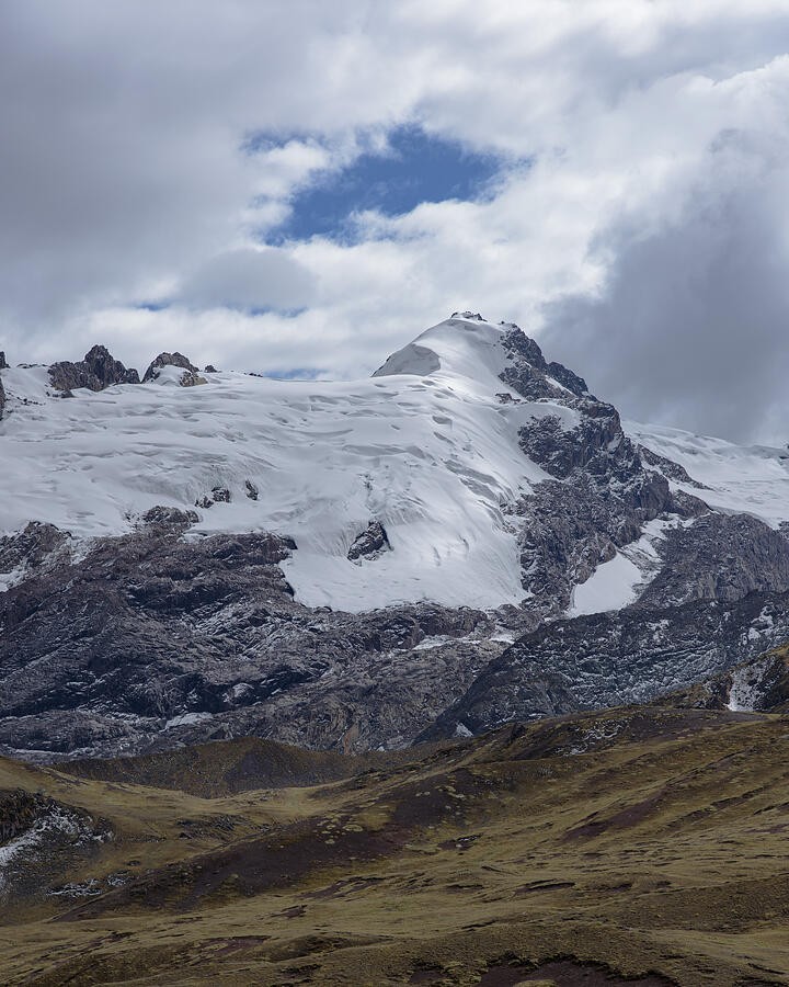 A Snowy Summit Above the Grassy Valley