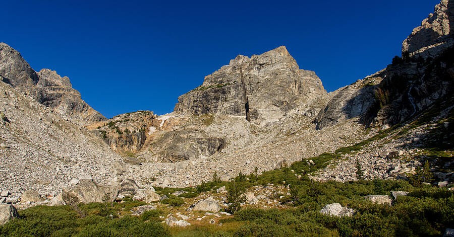 A Green Basin Beneath the Rocky Summit