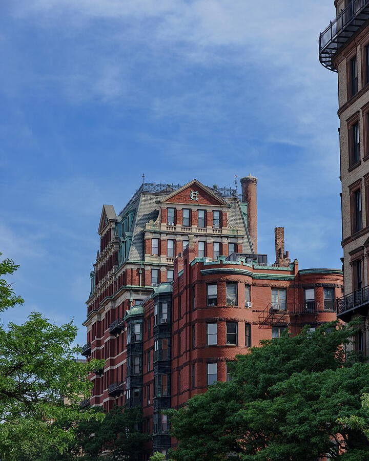Rounded Brick Facades Beneath Blue Clouds