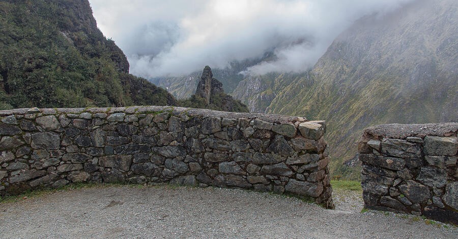A Low Stone Wall Before the Clouded Peaks