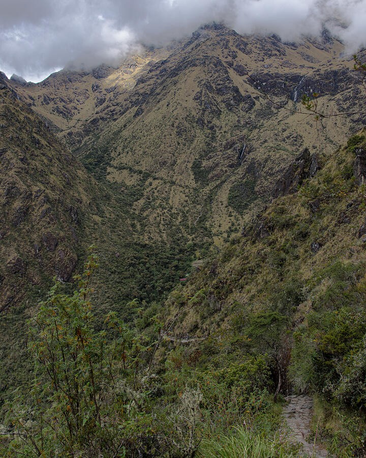 A Steep Green Valley Beneath the Clouded Crest