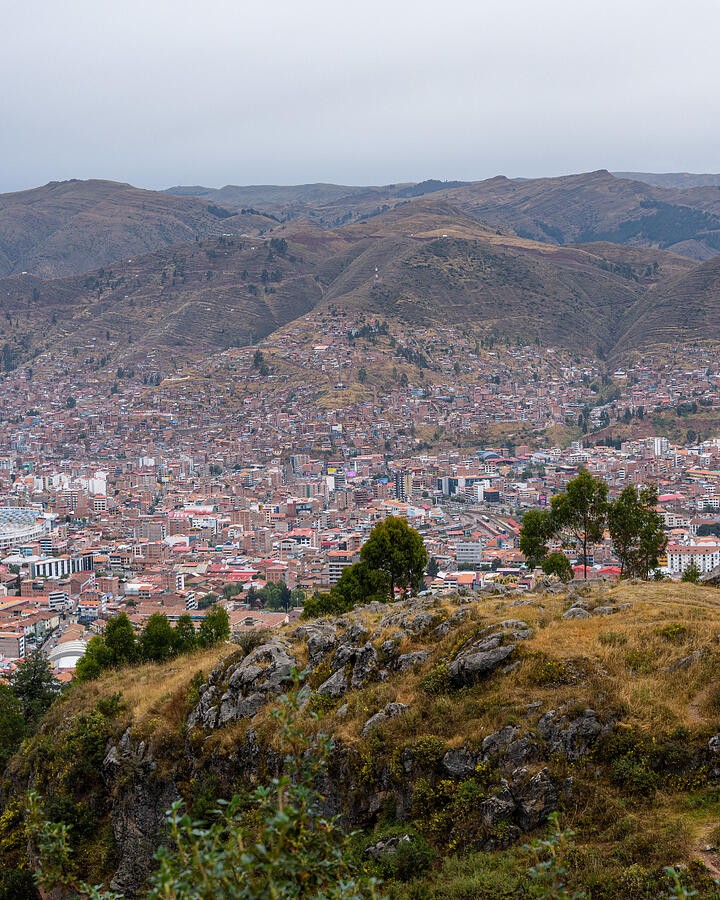 The City Beneath Layered Mountain Ridges