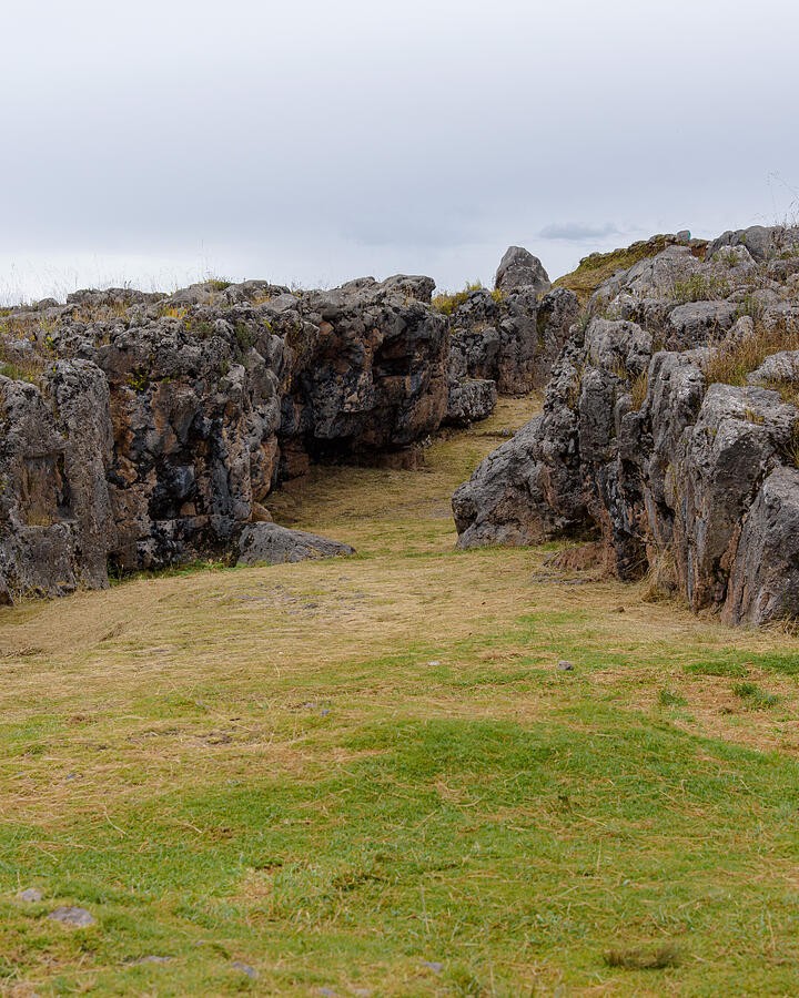 An Open Lawn Between Rugged Rocks