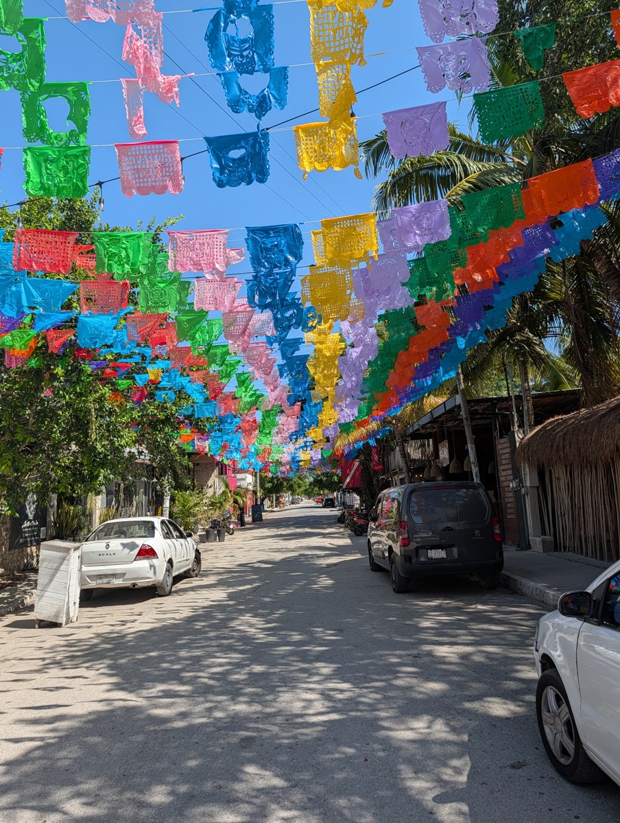 A street beneath colorful decorations